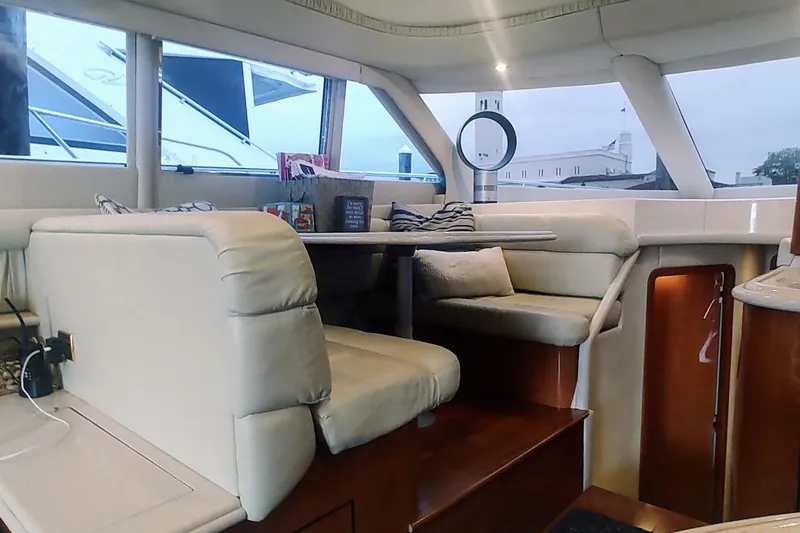 Slide: The Image of Luxurious interior of a 2001 Sea Ray 560 Sedan Bridge yacht with plush seating and elegant wood finishes. - 16