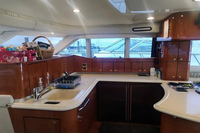 Slide: The Image of Luxurious interior of 2001 Sea Ray 560 Sedan Bridge yacht with plush seating and entertainment system. - 18