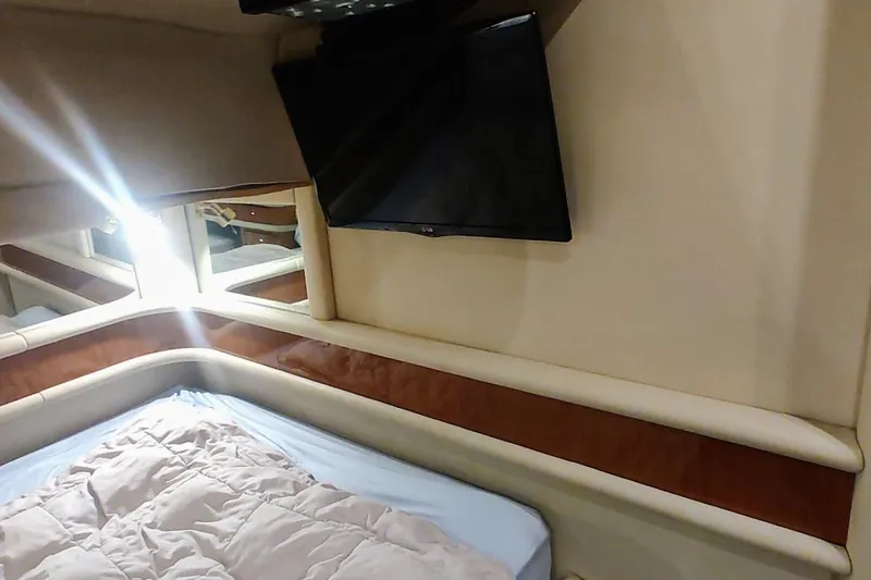 Slide: The Image of Luxurious interior of 2001 Sea Ray 560 Sedan Bridge yacht with plush seating and table. - 21