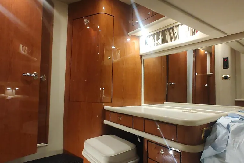 Slide: The Image of Luxurious interior of 2001 Sea Ray 560 Sedan Bridge with cozy seating and table. - 22