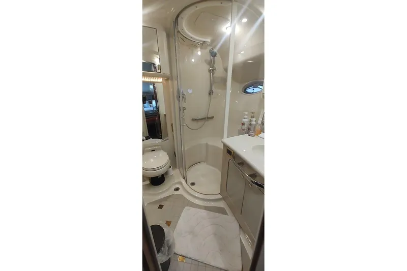 Slide: The Image of Luxurious cabin interior of 2001 Sea Ray 560 Sedan Bridge yacht with TV and bedding. - 26