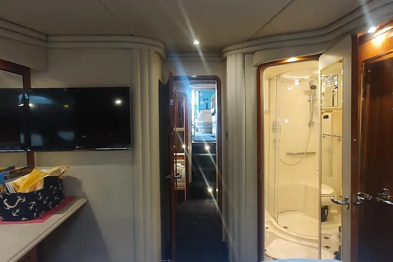 Slide: The Image of Luxurious 2001 Sea Ray 560 Sedan Bridge interior with wooden cabinetry and vanity area. - 27