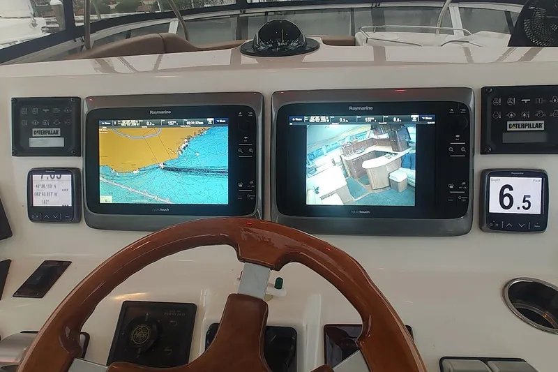 Slide: The Image of Staircase on 2001 Sea Ray 560 Sedan Bridge yacht with wooden deck and seating area. - 34