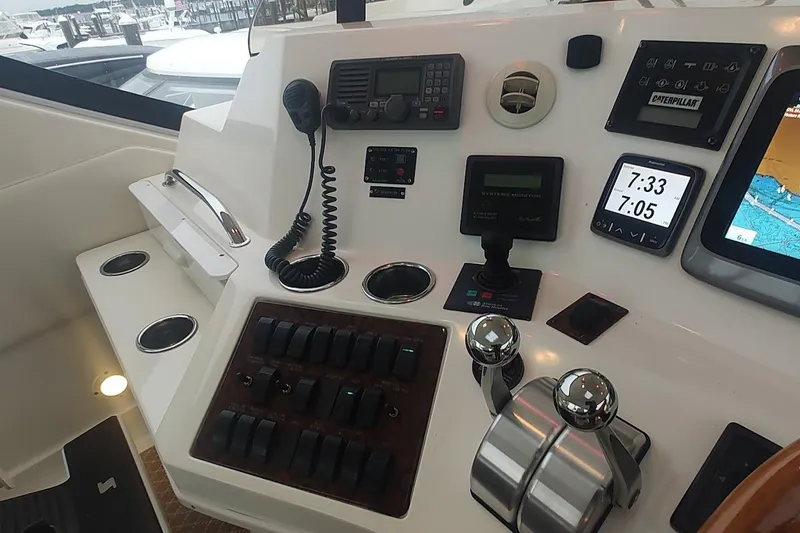 Slide: The Image of Interior view of 2001 Sea Ray 560 Sedan Bridge yacht with marina backdrop. - 35