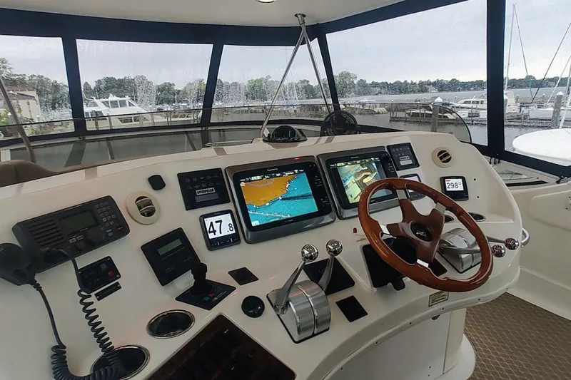 Slide: The Image of Interior of 2001 Sea Ray 560 Sedan Bridge with luxurious seating and marina view. - 36