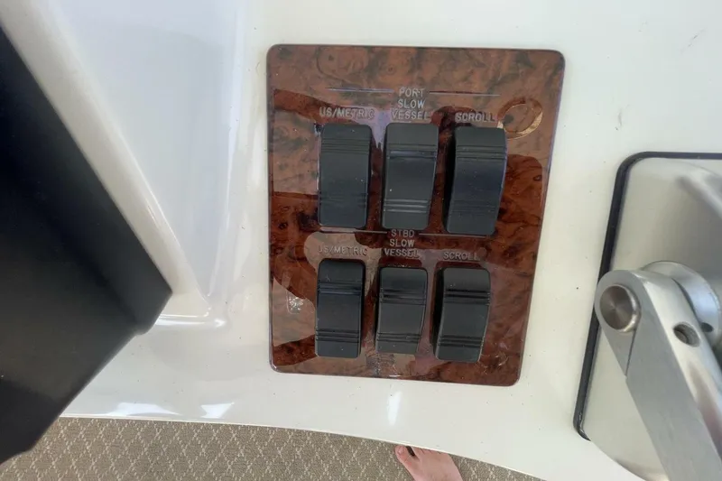 Slide: The Image of Control panel of a 2001 Sea Ray 560 Sedan Bridge yacht with navigation displays. - 38