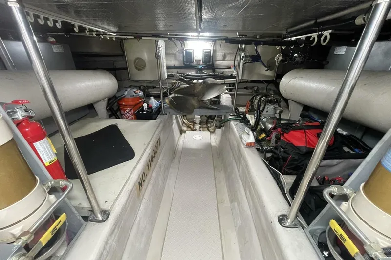 Slide: The Image of 2001 Sea Ray 560 Sedan Bridge interior with open storage and fan on counter. - 44