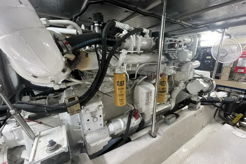 Slide: The Image of 2001 Sea Ray 560 Sedan Bridge interior with seating, table, and marina view. - 47