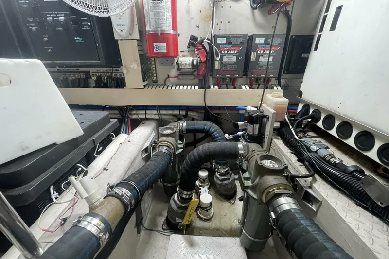 Slide: The Image of Engine room of a 2001 Sea Ray 560 Sedan Bridge with mechanical components and wiring. - 50