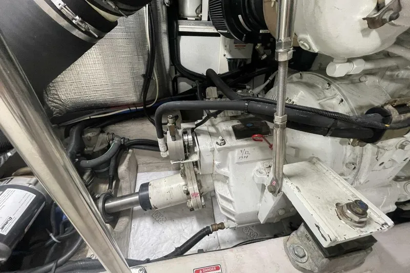 Slide: The Image of Engine room of a 2001 Sea Ray 560 Sedan Bridge, showcasing mechanical components and wiring. - 54