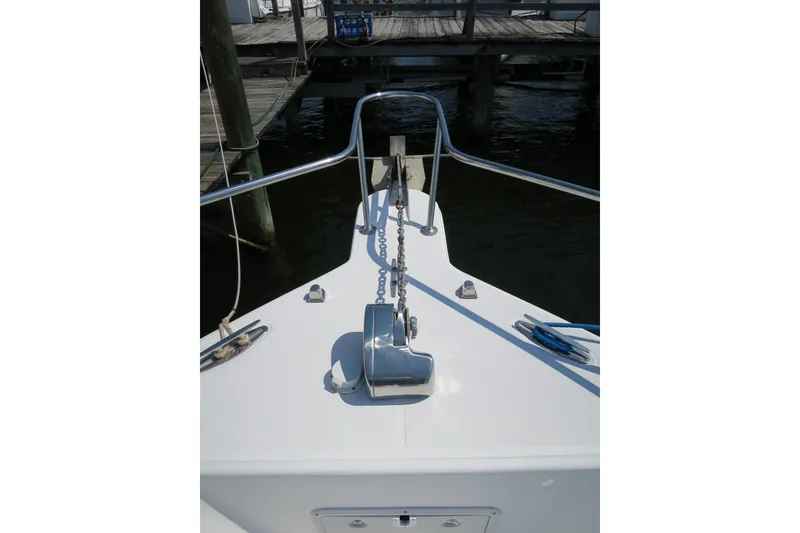Slide: The Image of 2000 PROLINE Sport Center Console boat bow with anchor chain and railing. - 2