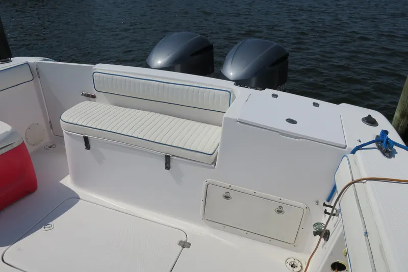 Slide: The Image of 2000 PROLINE Sport Center Console boat interior with seating and dual outboard motors. - 3
