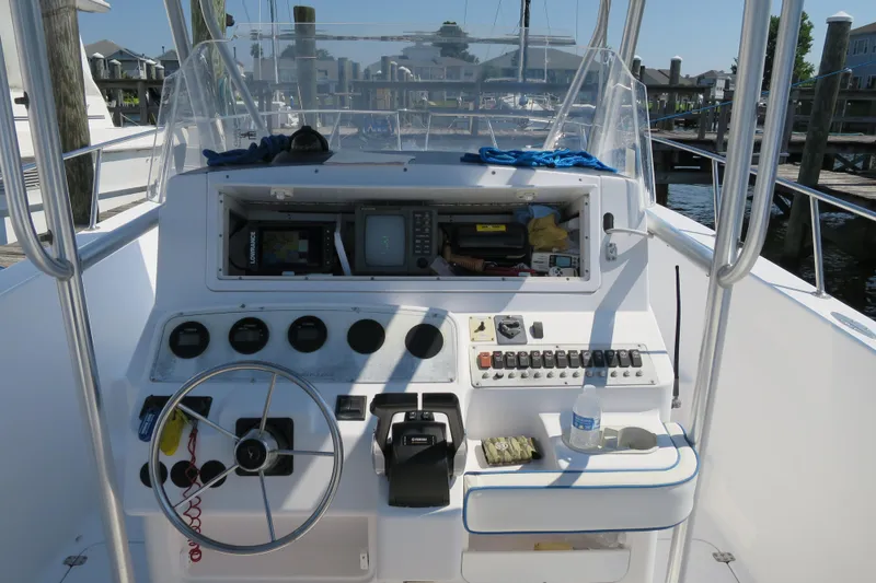 Slide: The Image of 2000 PROLINE Sport Center Console boat dashboard with steering wheel and control panel. - 4