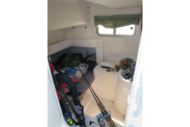 Slide: The Image of 2000 PROLINE Sport Center Console cabin interior with fishing gear and supplies. - 5