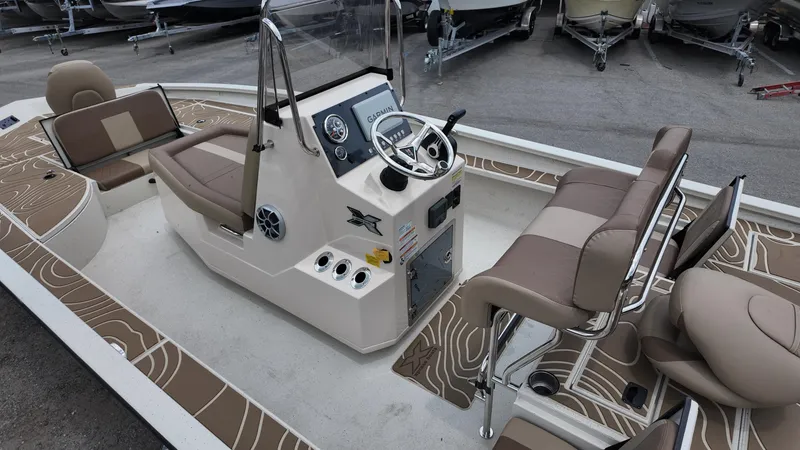Slide: The Image of 2025 Xpress X23B Lounge boat interior with seating and steering console. - 18