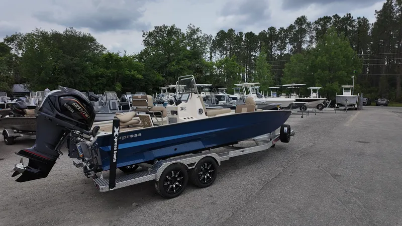 Slide: The Image of 2025 Xpress X23B Lounge boat on trailer in outdoor lot. - 4