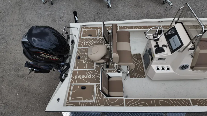 Slide: The Image of 2025 Xpress X23B Lounge boat interior with seating and steering console. - 8