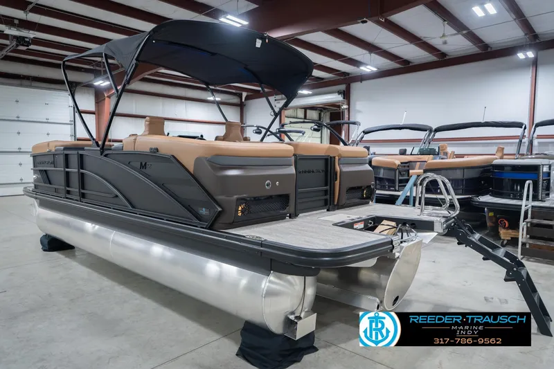 Slide: The Image of 2026 Bennington 22 MFB pontoon boat in showroom, featuring sleek design and modern amenities. - 10