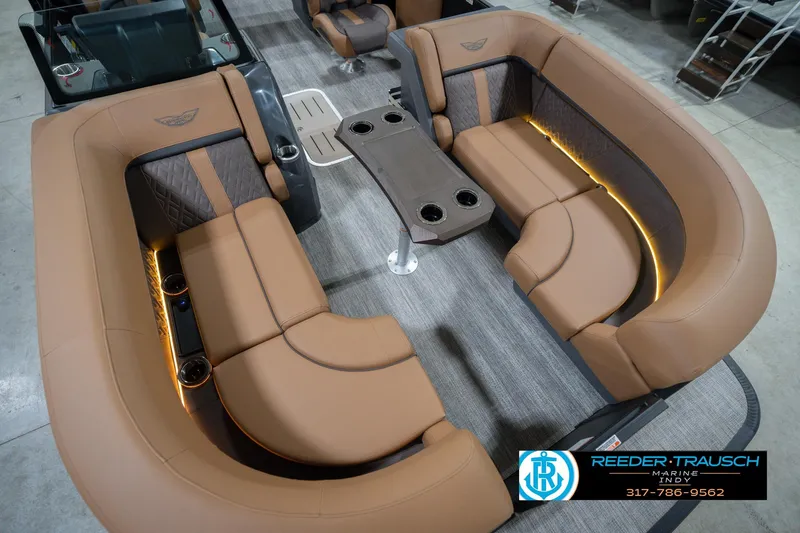 Slide: The Image of Luxurious interior of 2026 Bennington 22 MFB pontoon boat with tan seating and ambient lighting. - 13