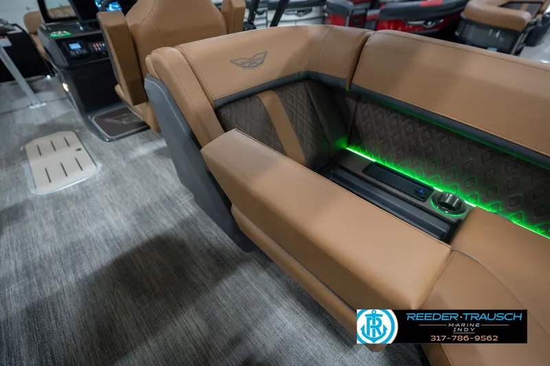 Slide: The Image of 2026 Bennington 22 MFB boat interior with tan seating and green LED lighting. - 35