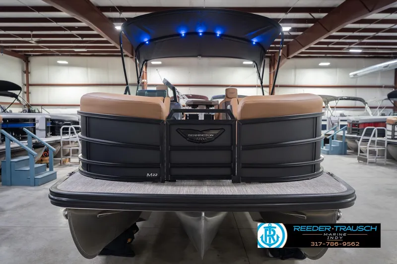 Slide: The Image of 2026 Bennington 22 MFB pontoon boat in showroom, featuring sleek design and modern seating. - 5