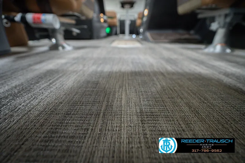 Slide: The Image of 2026 Bennington 22 MFB interior flooring with textured design, featuring Reeder Trausch Marine logo. - 52