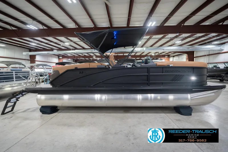 Slide: The Image of 2026 Bennington 22 MFB pontoon boat in showroom, featuring sleek design and modern amenities. - 7