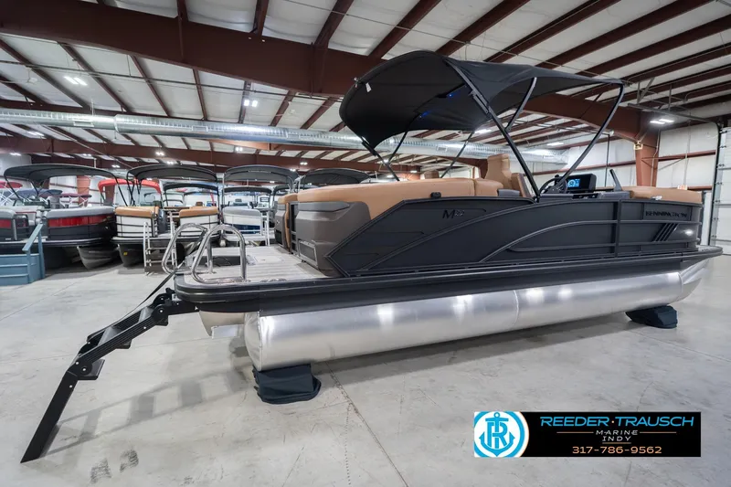 Slide: The Image of 2026 Bennington 22 MFB pontoon boat in showroom, featuring sleek design and modern amenities. - 8