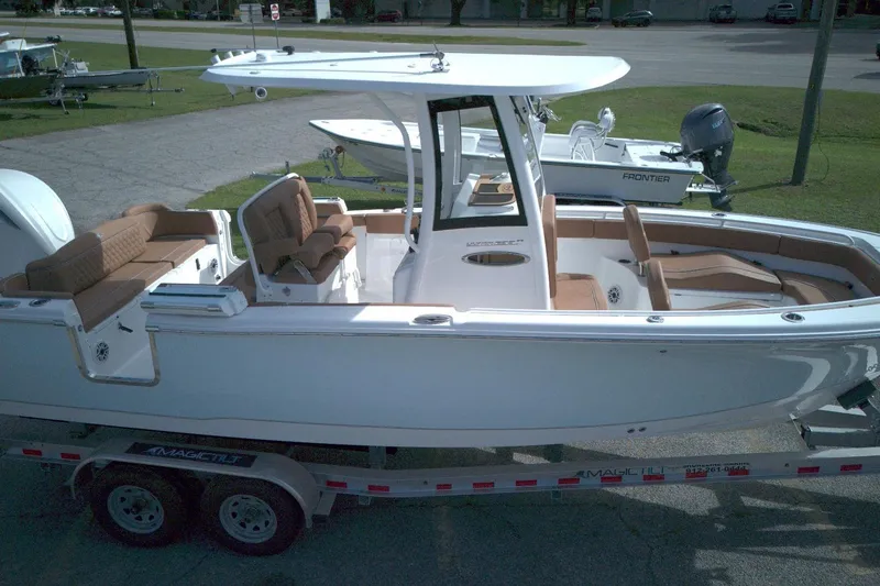 Slide: The Image of 2026 Sea Hunt Ultra 255 SE boat on trailer, featuring spacious seating and sleek design. - 11