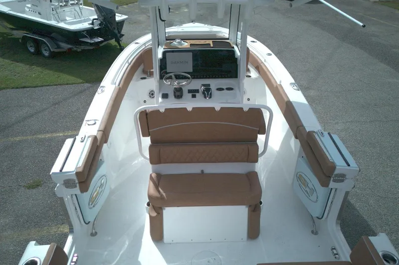 Slide: The Image of 2026 Sea Hunt Ultra 255 SE boat interior with tan seating and modern dashboard. - 2