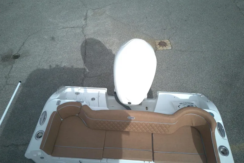 Slide: The Image of 2026 Sea Hunt Ultra 255 SE boat with brown seating and white motor, viewed from above. - 3