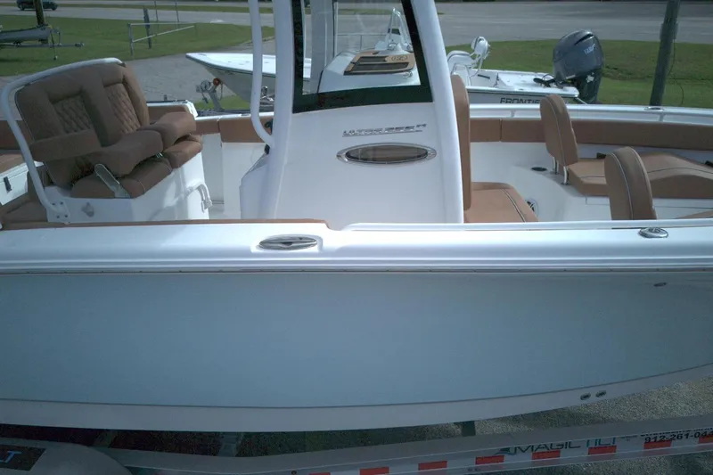 Slide: The Image of 2026 Sea Hunt Ultra 255 SE boat interior with brown seating and modern design. - 4