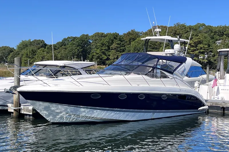 Slide: The Image of 2006 Fairline Targa 40 yacht docked at marina, surrounded by trees and other boats. - 1