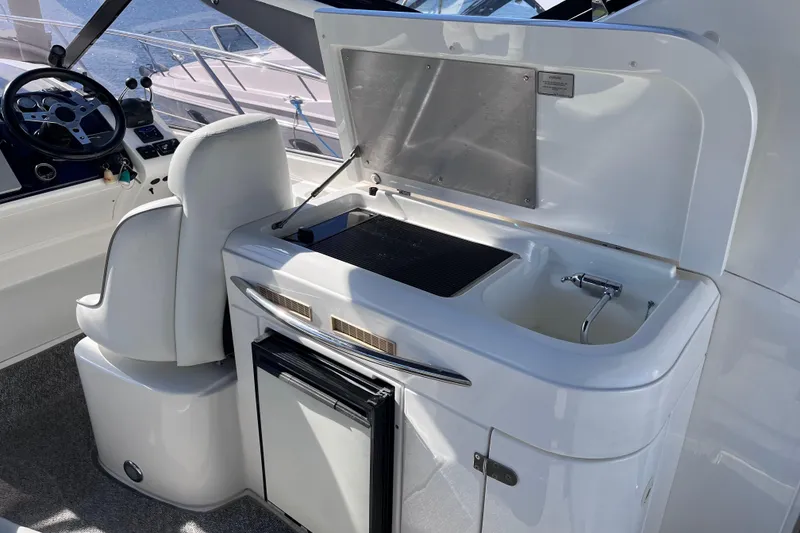 Slide: The Image of Interior of 2006 Fairline Targa 40 yacht with helm and kitchenette area. - 10