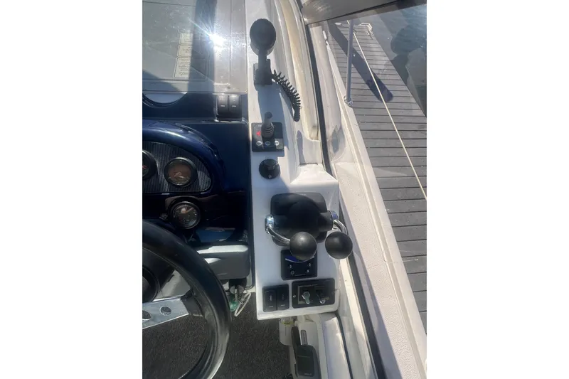 Slide: The Image of Control panel of a 2006 Fairline Targa 40 yacht, featuring steering and throttle controls. - 17