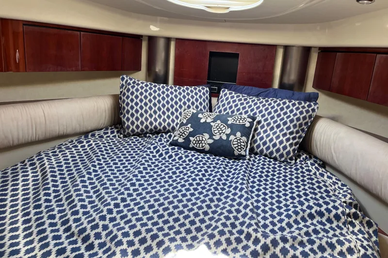 Slide: The Image of Cozy cabin interior of 2006 Fairline Targa 40 with patterned bedding and wooden cabinets. - 23
