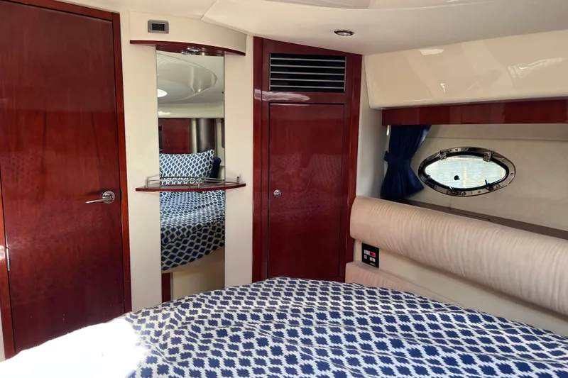 Slide: The Image of Interior of 2006 Fairline Targa 40 yacht with wood finish and patterned bedding. - 24
