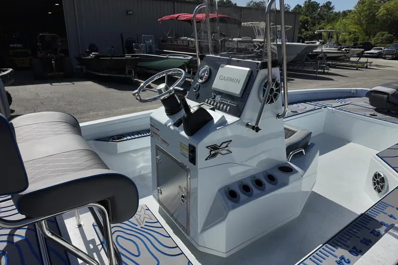 Slide: The Image of 2026 Xpress H22B Bay boat with Garmin navigation, sleek console, and comfortable seating. - 13