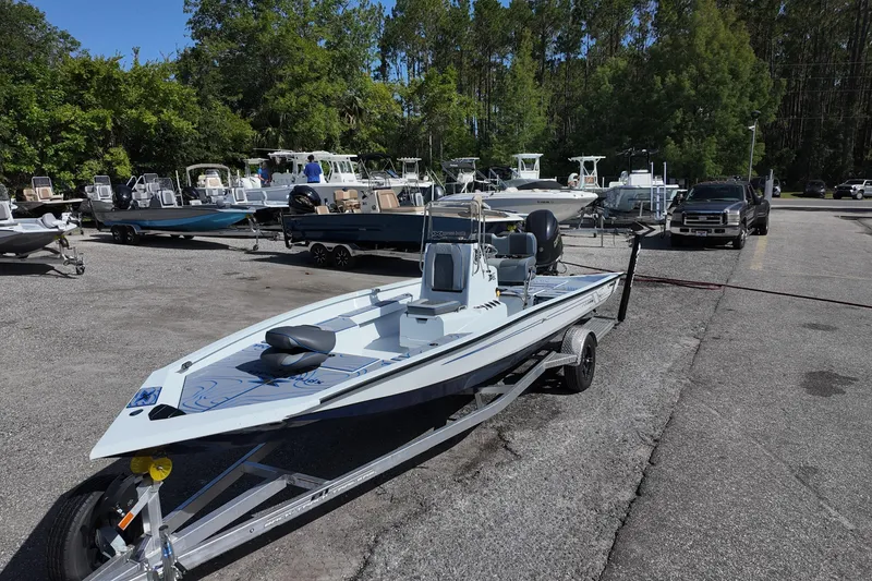 Slide: The Image of 2026 Xpress H22B Bay boat on trailer in a marina parking lot. - 3