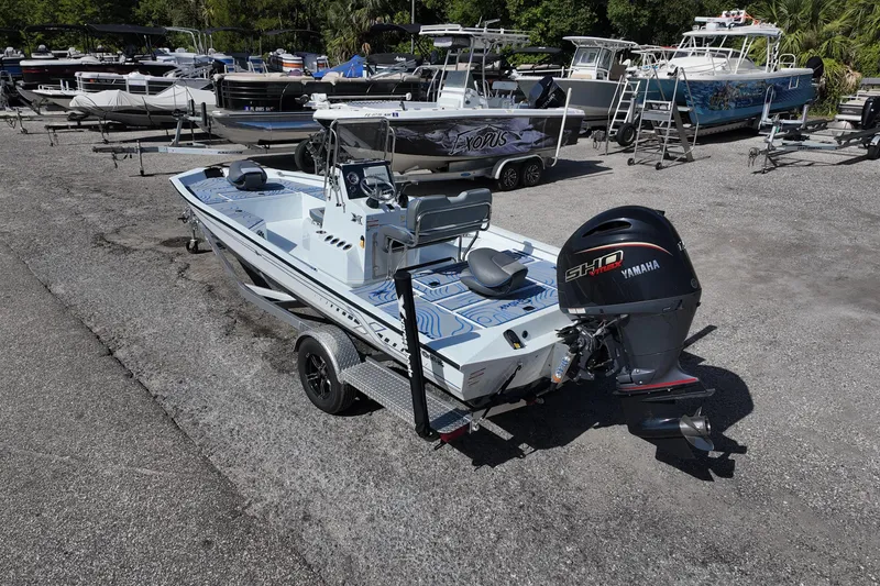 Slide: The Image of 2026 Xpress H22B Bay boat with Yamaha engine in a marina setting. - 5