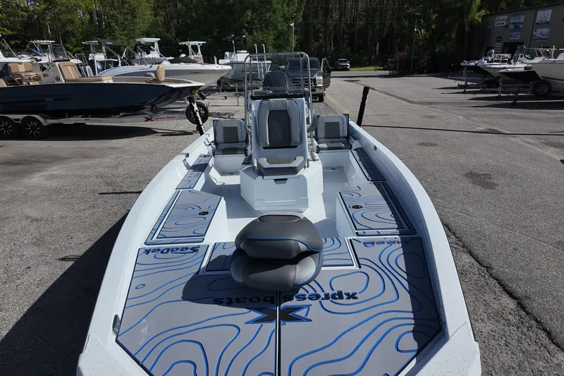 Slide: The Image of 2026 Xpress H22B Bay boat with custom deck design in a marina setting. - 9