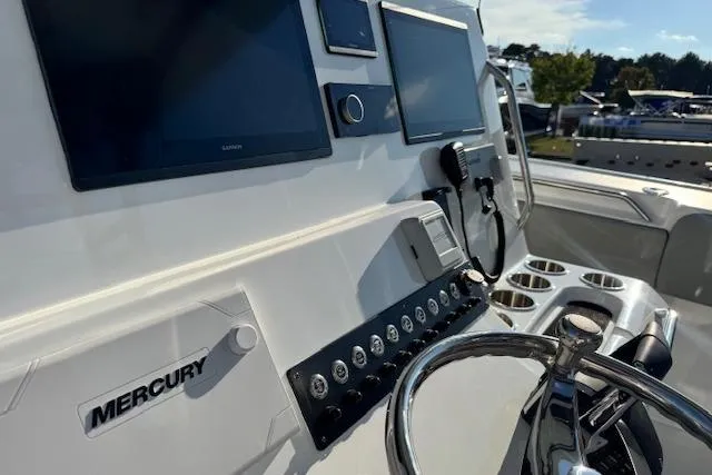Slide: The Image of 2026 Cape Horn 36 XS boat dashboard with Mercury controls and multiple screens. - 1