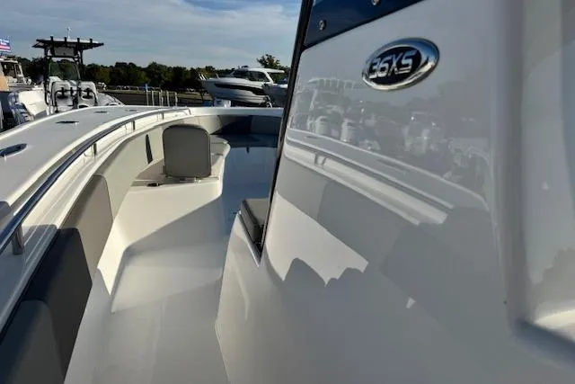 Slide: The Image of 2026 Cape Horn 36 XS boat, sleek design, white exterior, docked under clear sky. - 2