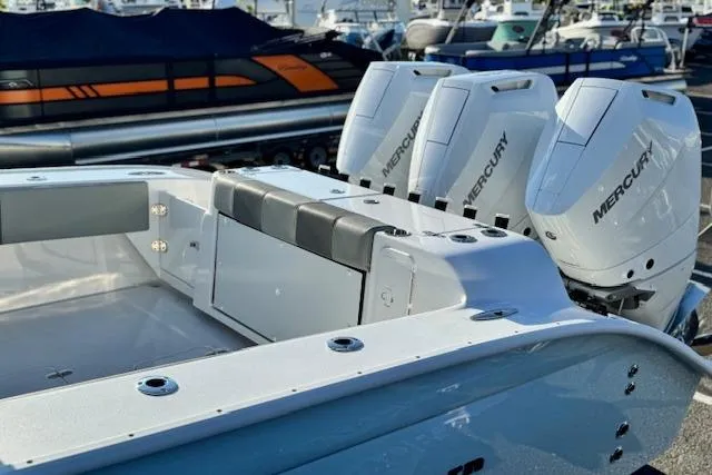 Slide: The Image of 2026 Cape Horn 36 XS boat with triple Mercury engines at a marina. - 16