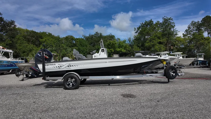 The Image of 2026 Xpress H20 boat on trailer, parked outdoors under a clear blue sky. - 0