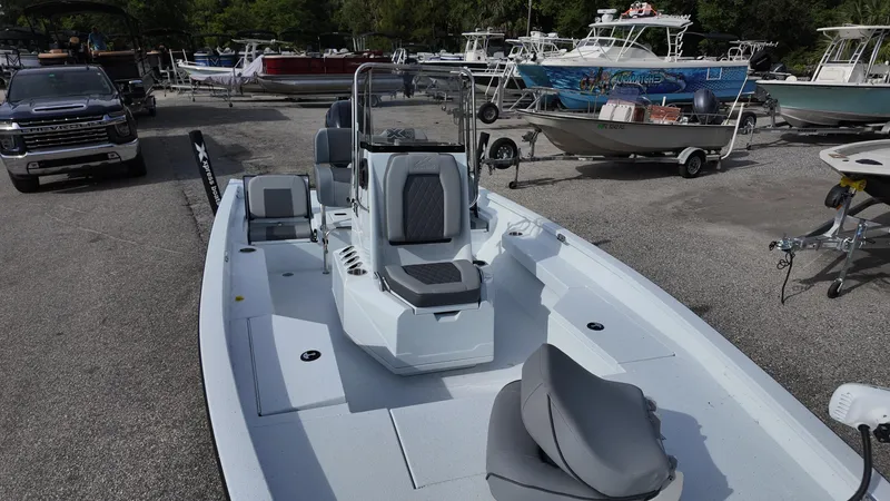 Slide: The Image of 2026 Xpress H20 boat displayed in a marina with various other boats and a truck. - 11