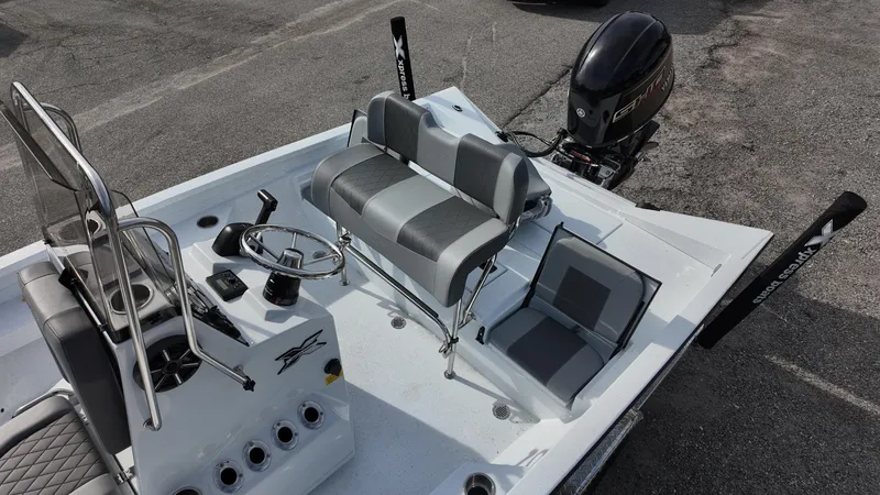 Slide: The Image of 2026 Xpress H20 boat interior with steering console and seating, featuring a powerful outboard motor. - 15