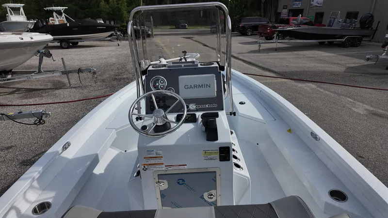 Slide: The Image of 2026 Xpress H20 boat interior with Garmin navigation system, steering wheel, and control panel. - 17