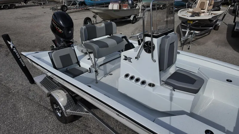 Slide: The Image of 2026 Xpress H20 boat with sleek design, dual seating, and powerful outboard motor. - 7