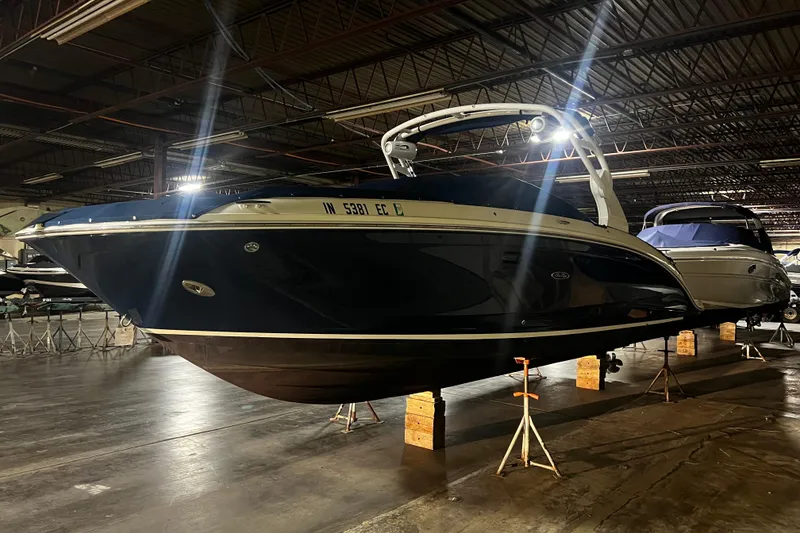 Slide: The Image of 2019 Sea Ray SDX 290 boat in indoor storage, elevated on stands. - 10